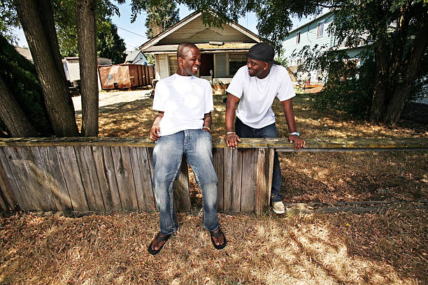 istock Two Friends Laughing and Leaning on Broken Fence 90848981