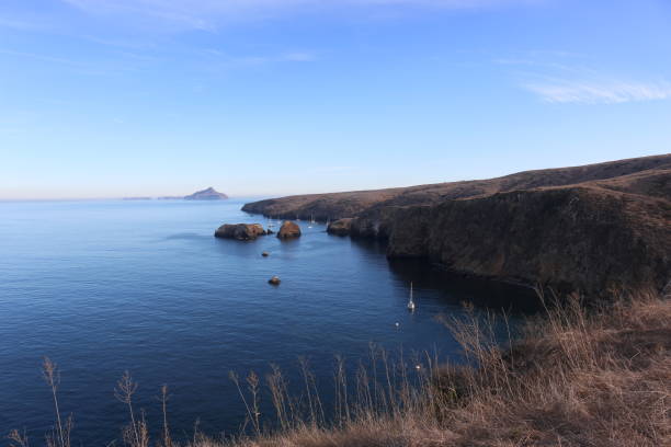 Santa Cruz Island with Anacapa in the Distance Cliff by the ocean on Santa Cruz Island in the Channel Islands with Anacapa Island in the distance anacapa island stock pictures, royalty-free photos & images