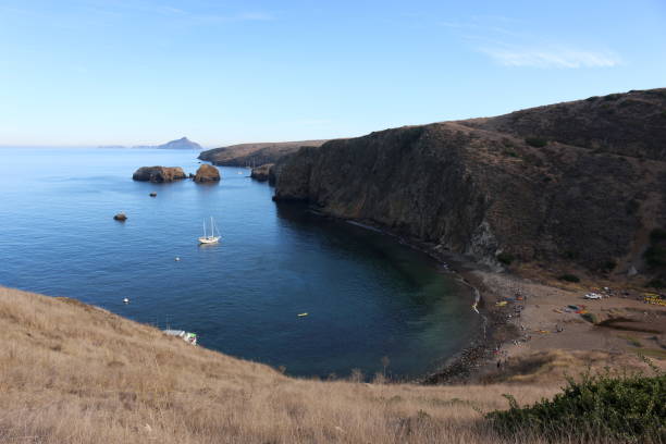 Santa Cruz Island with Anacapa in the Distance Cliff by the ocean on Santa Cruz Island in the Channel Islands with Anacapa Island in the distance anacapa island stock pictures, royalty-free photos & images