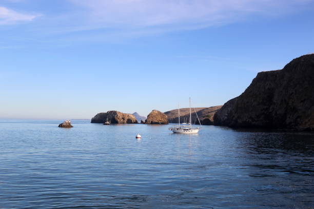 Santa Cruz Island with Anacapa in the Distance Cliff by the ocean on Santa Cruz Island in the Channel Islands with Anacapa Island in the distance anacapa island stock pictures, royalty-free photos & images