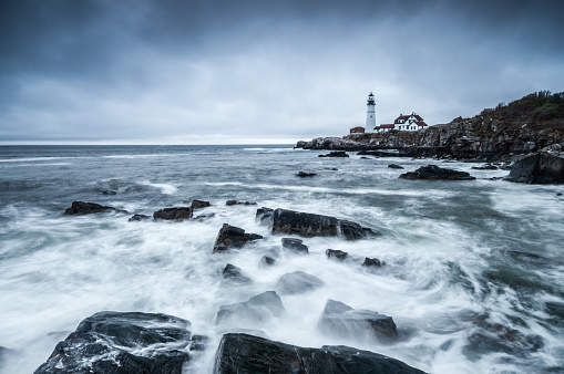 A long exposure of the waves washing over the rocks near the lighthouse at Portland Head, Maine.