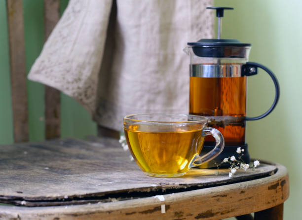 istock kettle French press with fragrant tea on a wooden table 908492878