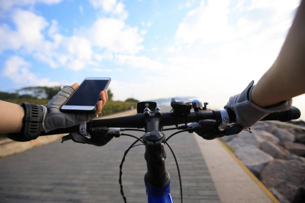 istock Cyclist using smartphone for navigation when riding mountain bike on the coast path 908496428