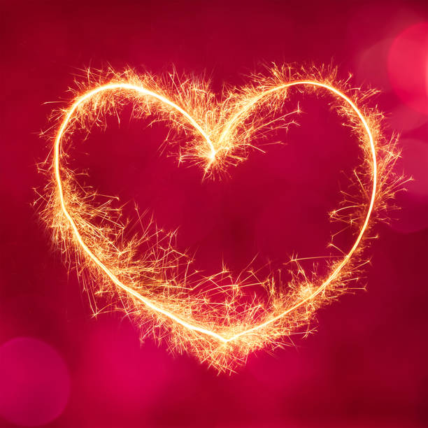 istock Decorative festive red background with glowing gold heart 908508594