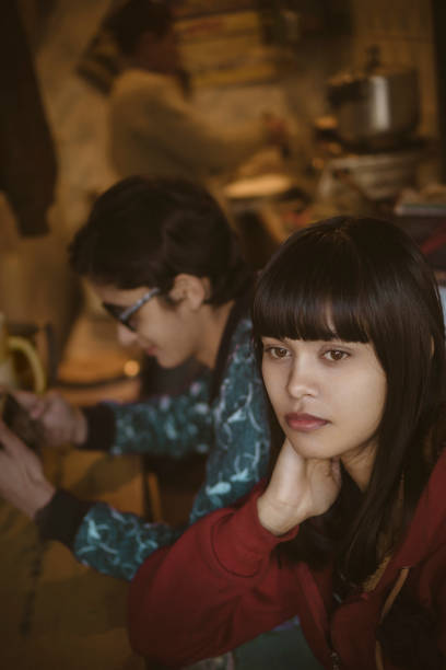 istock Young woman sitting in kitchen and thinking. 908512192