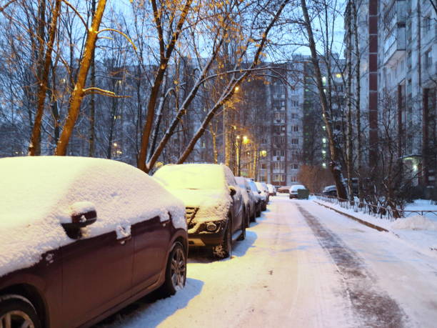 istock parking in urban blocks in the snow on a winter evening 908518310