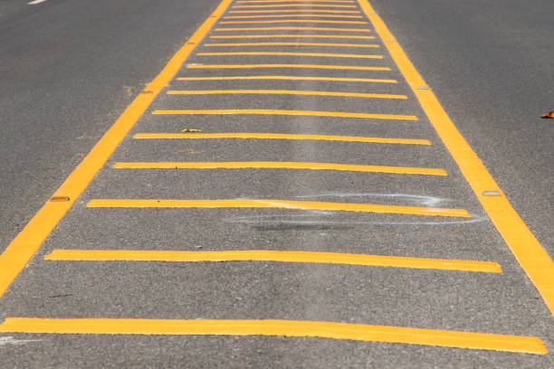 istock Yellow color road line on asphalt background 908518964
