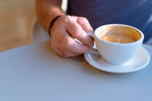 istock Close-up Of Senior Man Hand Holding Coffee Cup 908521034