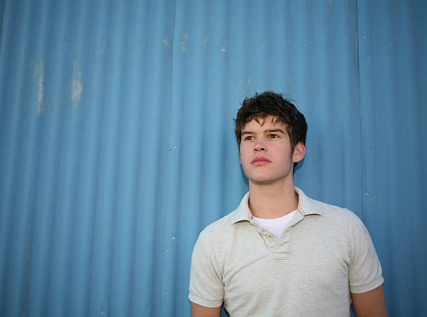 istock Teenage boy against blue building 90852651