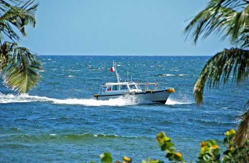 Pilot boat returning to port at tropical destination