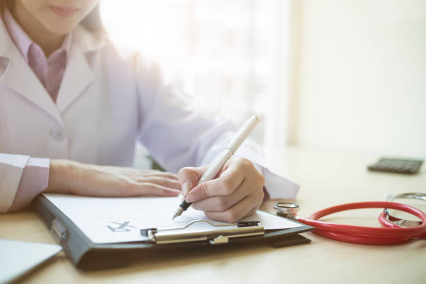istock Doctor writing on paper in hospital. 908532280