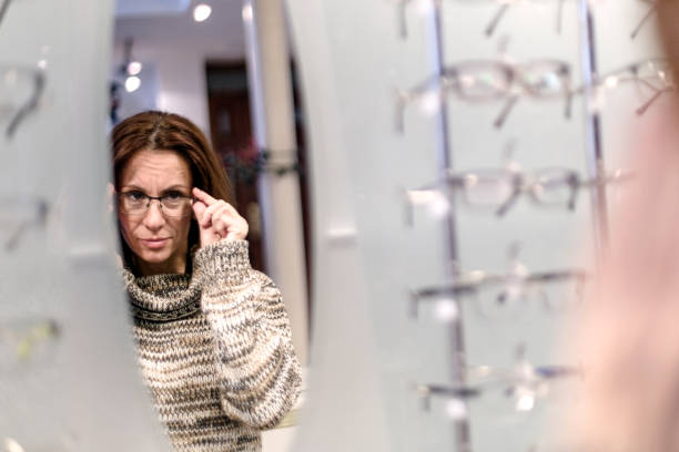 istock Young woman with glasses in optical shop 908534718
