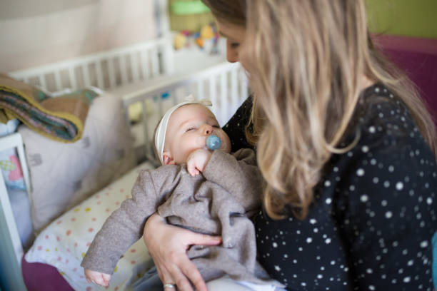 istock Sleeping Safely In Mother's Arms 908535008