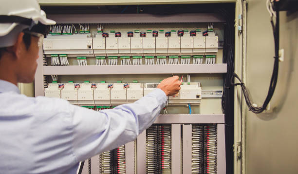 istock Control Room Engineer. Power Plant Control Panel. Engineer standing in front of the control panel in the control room and write the results of the measurements. 908535282