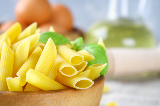 istock Penne rigate. Macaroni in the form of feathers. mostaccioli pasta. 908538472