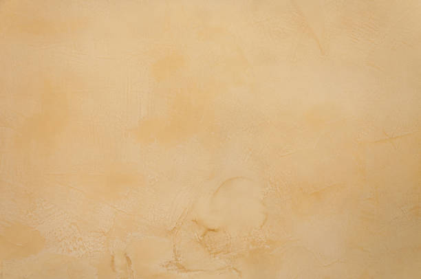 istock Texture of a  yellow brown concrete as a background 908542580