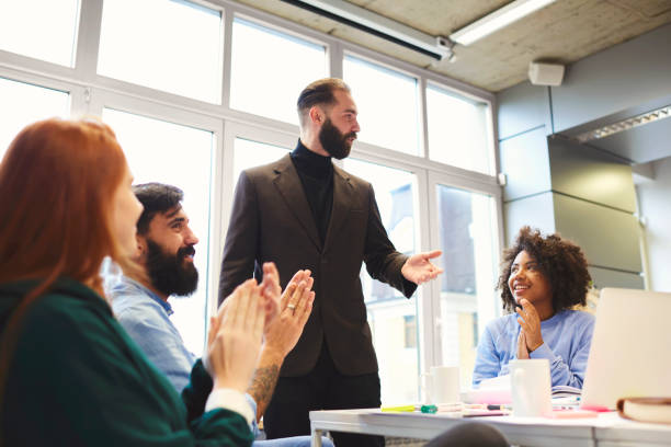 istock Confident proud CEO congratulate talented group of freelancers making great job working on startup project collaborating to achieve success using modern technologies and wireless internet in office 908542672