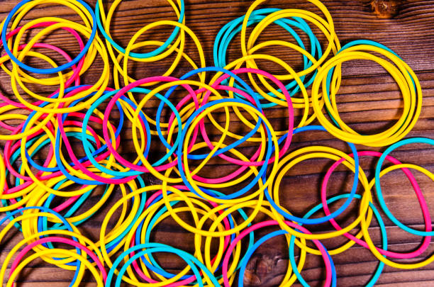 istock Multicolored rubber bands on wooden table. Top view 908543112