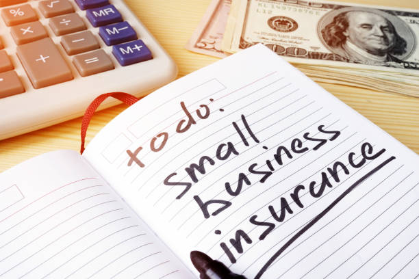 istock Small business insurance written in a note pad. 908547394