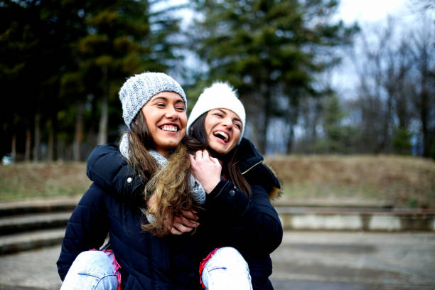 istock Two young women having fun in the park 908550642