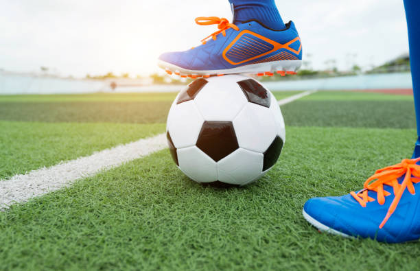 istock Football player feet waiting for kick off 908551040