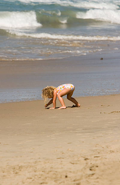 istock LITTLE GIRL PLAYS ON BEACH 90855317