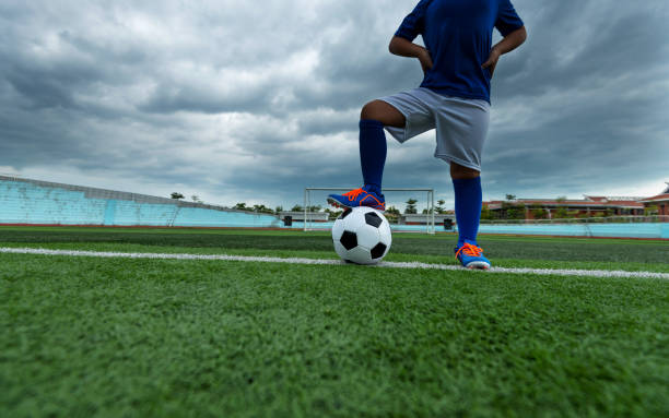 istock Football player feet waiting for kick off 908553422
