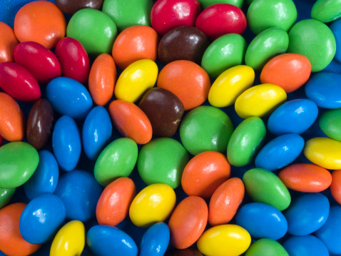 Assorted colorful gummy candies. Top view. Jelly donuts. Jelly bears. Isolated on a white background.