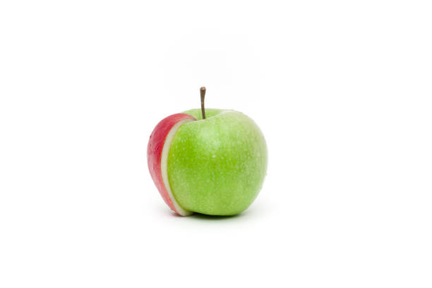 istock Fresh green apple with a slice of red attached 908558160