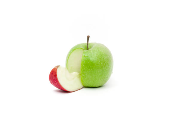 istock Fresh green apple with a slice of red 908558174