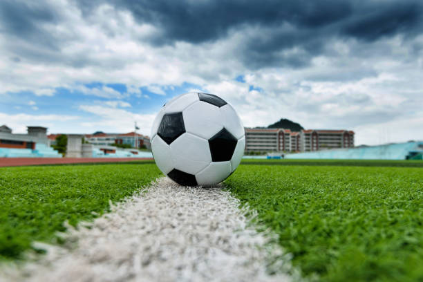 istock Soccer ball on white line 908560914