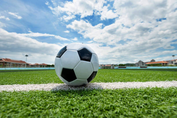 istock Soccer ball on white line 908561304