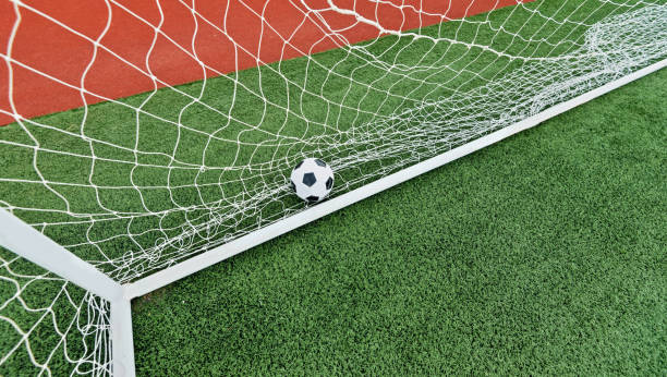 istock Soccer ball into the goal 908561780