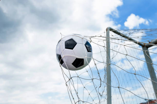 istock Soccer ball hitting the net 908562944