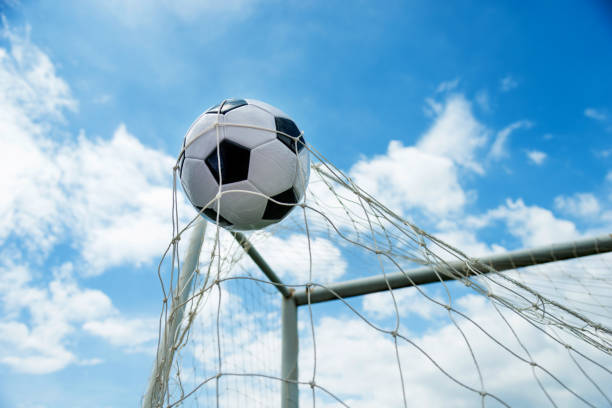 istock Soccer ball hitting the net 908564080