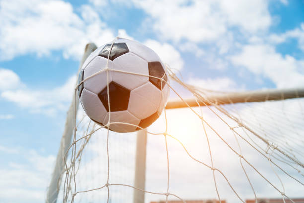 istock Soccer ball hitting the net 908564082