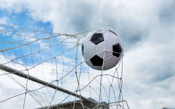 istock Soccer ball hitting the net 908564154