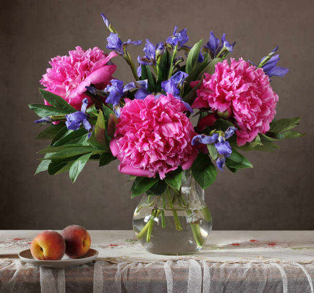 istock Still life with flowers and fruit. 908564202