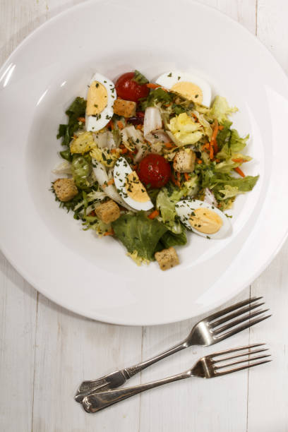 istock salad dish with croutons, cherry tomatoes, boiled egg quarters and dried parsley 908564666