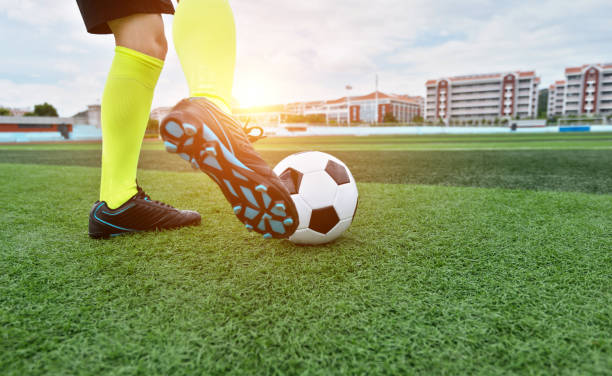 istock Soccer player foot kicking soccer ball 908564688