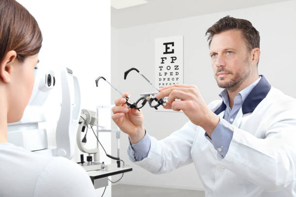 istock optometrist with trial frame examining eyesight  woman patient in optician office 908568132