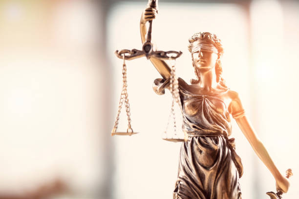 istock Justice blindfolded lady holding scales and sword statue 908570654