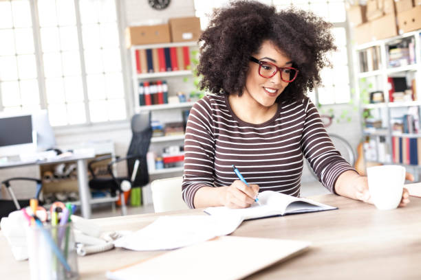 istock Smiling woman resting at workplace 908571250