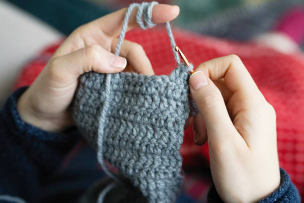 istock Woman Knitting at home 908571612
