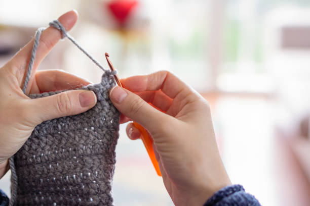 istock Woman Knitting at home 908571734