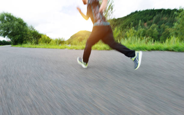 istock Boy legs running in the park footpath 908578406