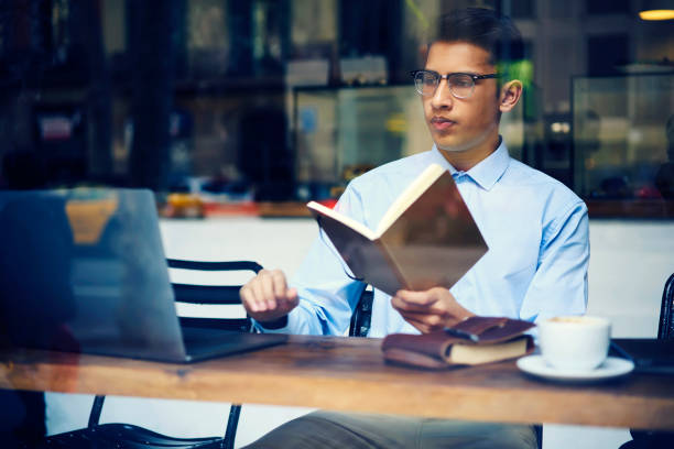 istock Intelligent concentrated male student searching information in internet 908578694