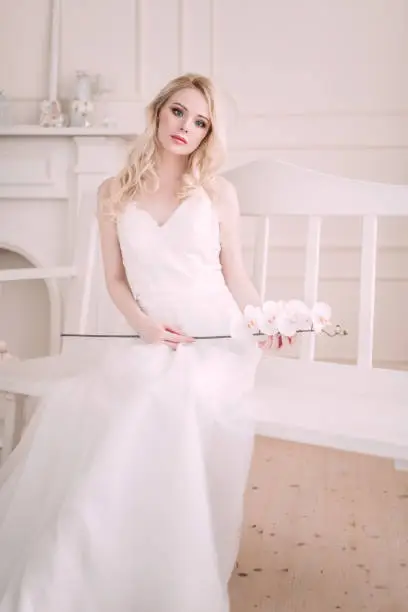 Photo of Portrait of a beautiful blond girl in image of the bride . Beauty face. Photo shot in the Studio on a light background