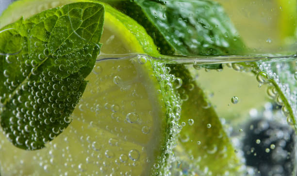 Close up of cocktail with lime , ice  and mint  . Close up of cocktail with lime , ice  and mint leaves . tonic water stock pictures, royalty-free photos & images