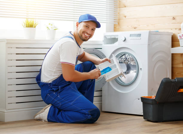 istock working man   plumber repairs  washing machine in   laundry 908590302